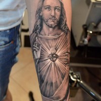 Colorful jesus crucified on a cross forearm tattoo - Tattooimages.biz