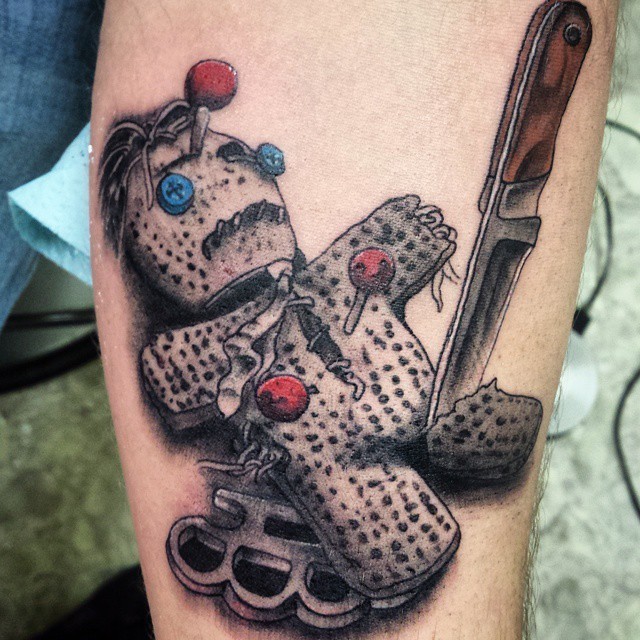 3D amazing looking colorful thug voodoo doll tattoo on arm with knife