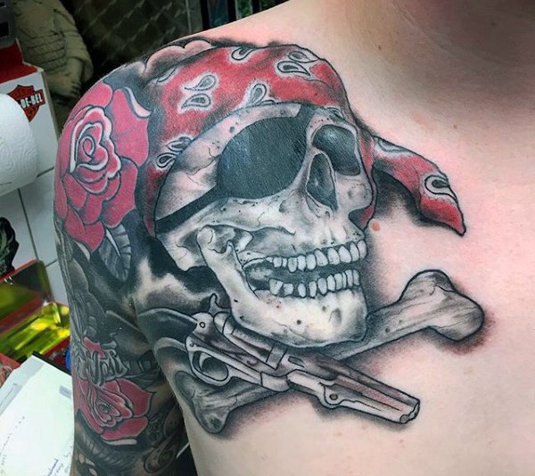 3D cartoon like colored shoulder tattoo of pirate skull with roses and pistol