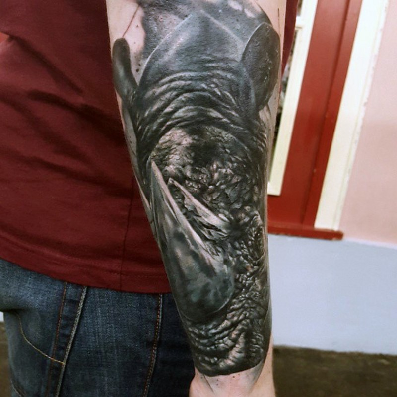 3D detailed colored angry rhino head tattoo on forearm zone