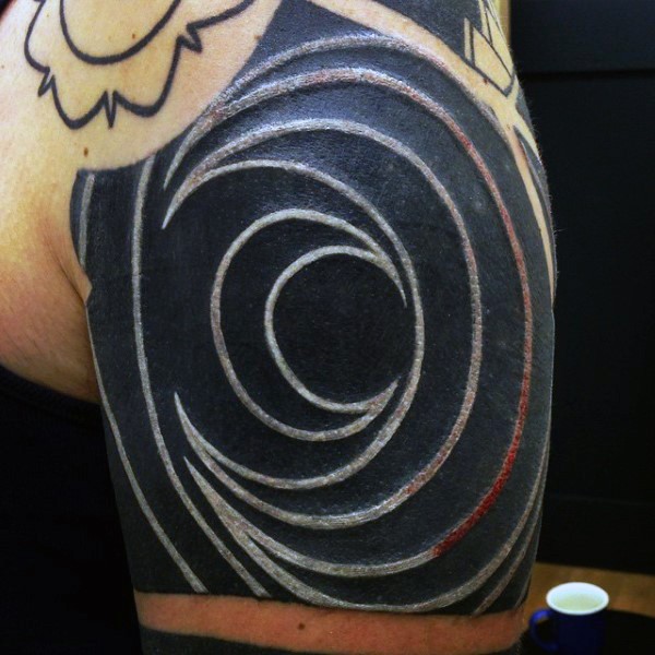 3D like black and white moon shaped tattoo on shoulder
