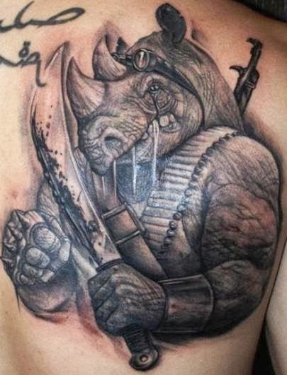 3D like black and white upper back tattoo of Teenage Mutant Ninja Turtles cartoon rhino villain