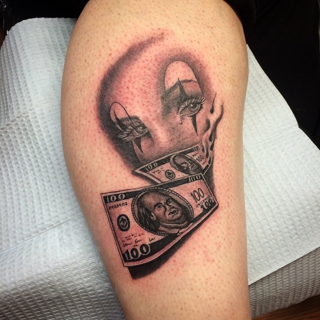 3D like black ink clown mask tattoo combined with dollars bills