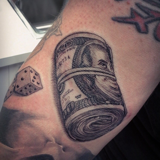3D like black ink detailed dollar bills roll with dice tattoo