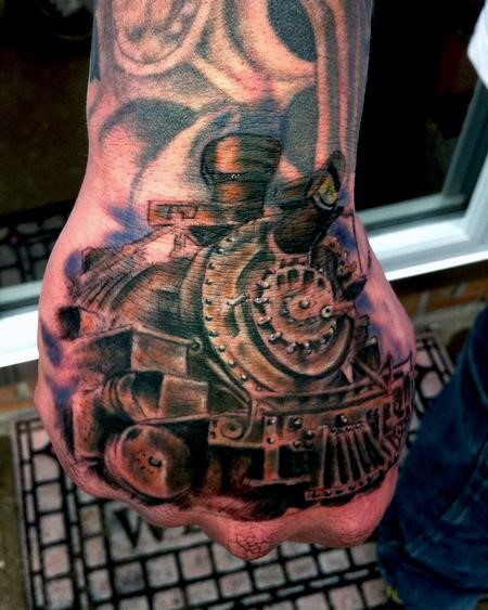 3D like colored detailed train tattoo on fist