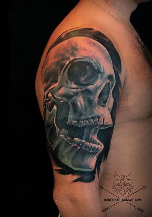 3D like colored natural looking big upper arm tattoo of human skull