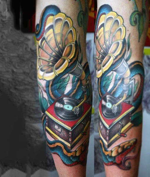 3D like cool detailed and colored antic gramophone tattoo on arm