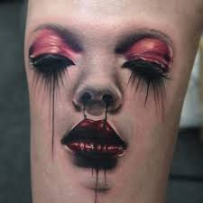 3D like creepy colored bloody womans face tattoo on leg