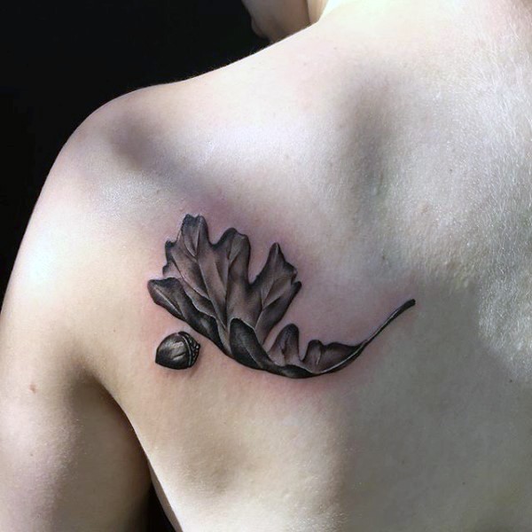 3D like little black ink oak leaf tattoo on shoulder