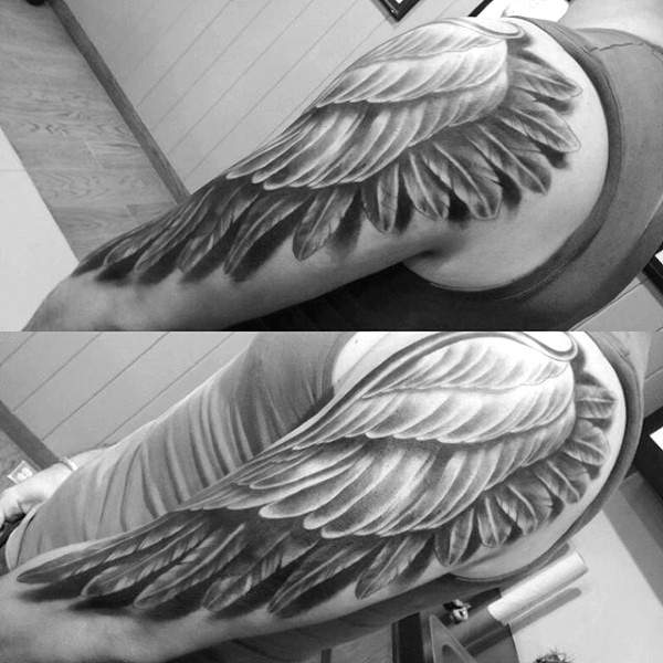 3D like massive black ink feather wing tattoo on shoulder