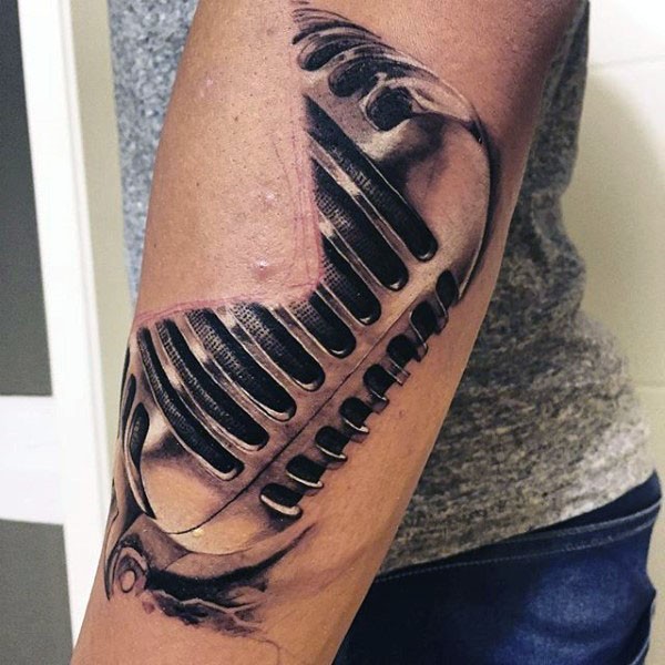 3D like massive very detailed vintage microphone tattoo on arm