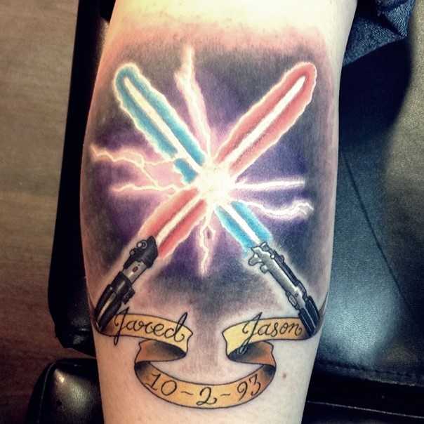 3D like memorial style colorful lightsaber tattoo on forearm with lettering