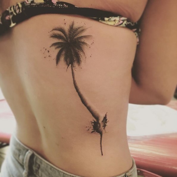 3D like natural looking black ink back tattoo of palm tree