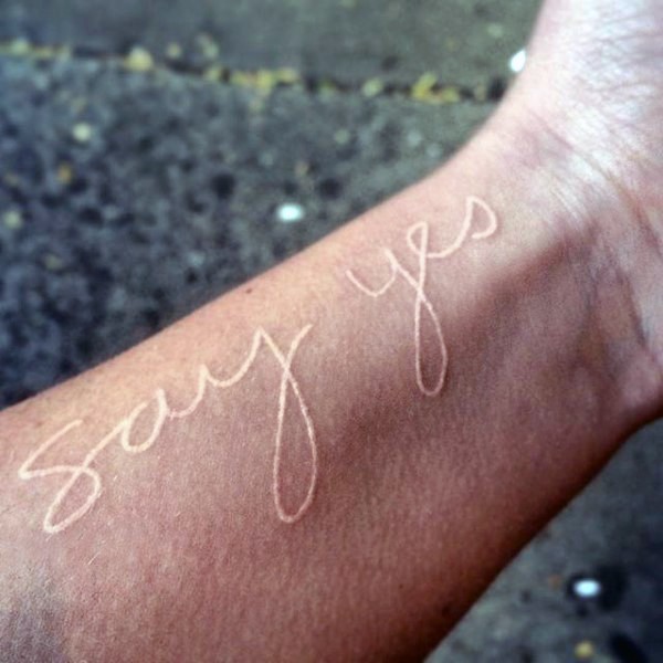 3D like romantic white ink lettering tattoo on wrist
