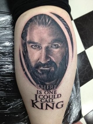 3D like The Hobbit hero portrait tattoo stylized with lettering on leg