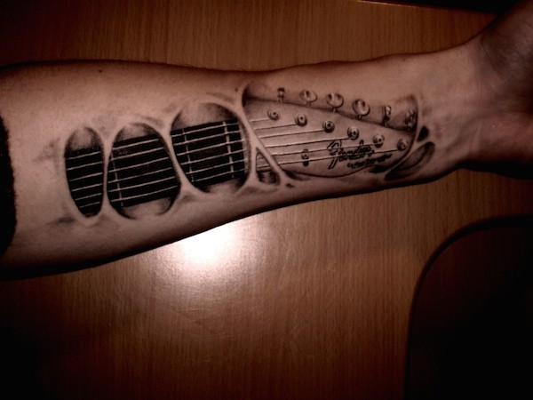 3D like very detailed black ink under skin guitar tattoo on forearm