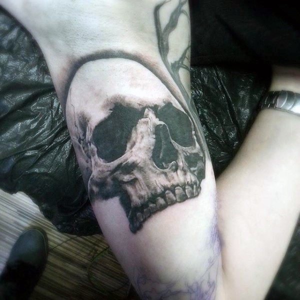 3D like very realistic black and white skull tattoo on arm