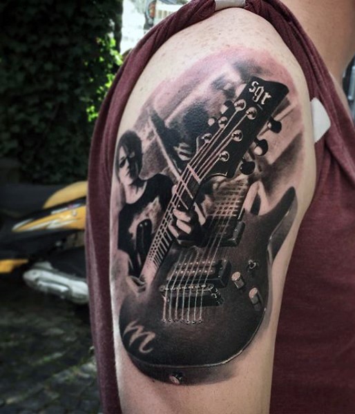 3D like very realistic looking black and white modern guitar tattoo on shoulder