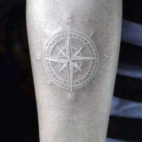 3D like white ink little compass tattoo on leg