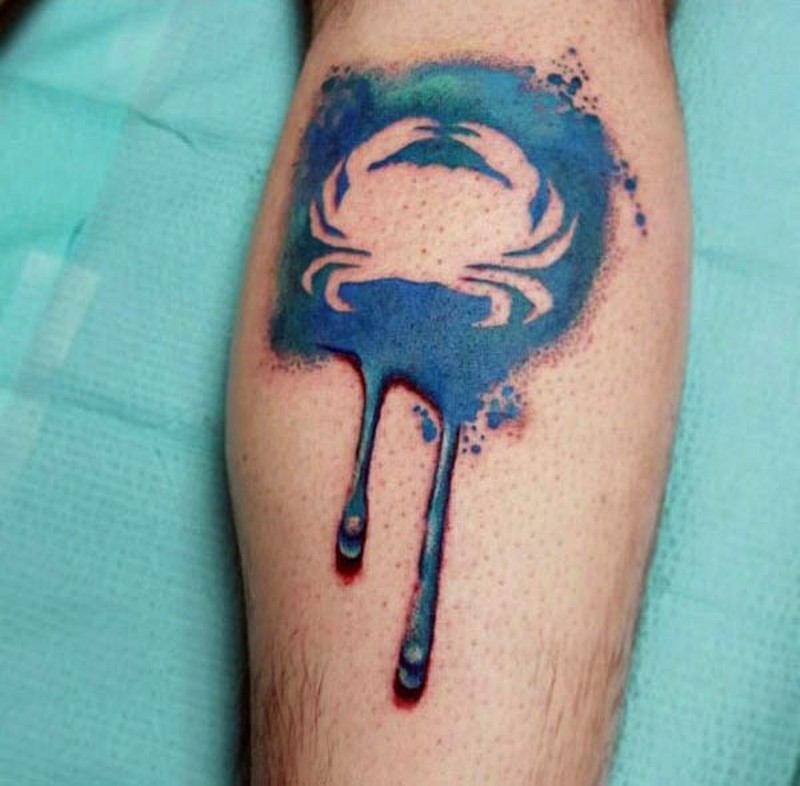 Tatuaje en el brazo, huella de cangrejo  en mancha azul