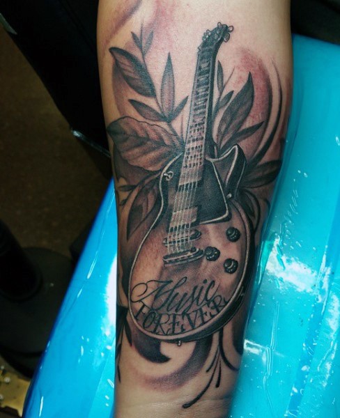 3D realistic looking black and white guitar with lettering tattoo on arm