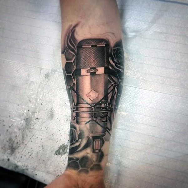 3D realistic looking black ink microphone tattoo on arm