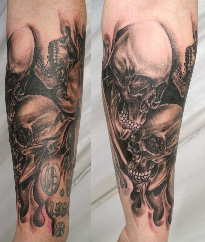 3D realistic massive black and white skulls in flames tattoo on arm