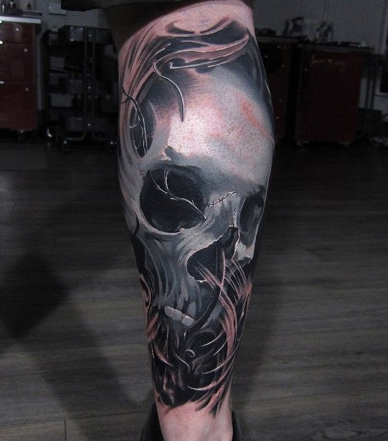 3D realistic painted big colored skull in fog tattoo on leg