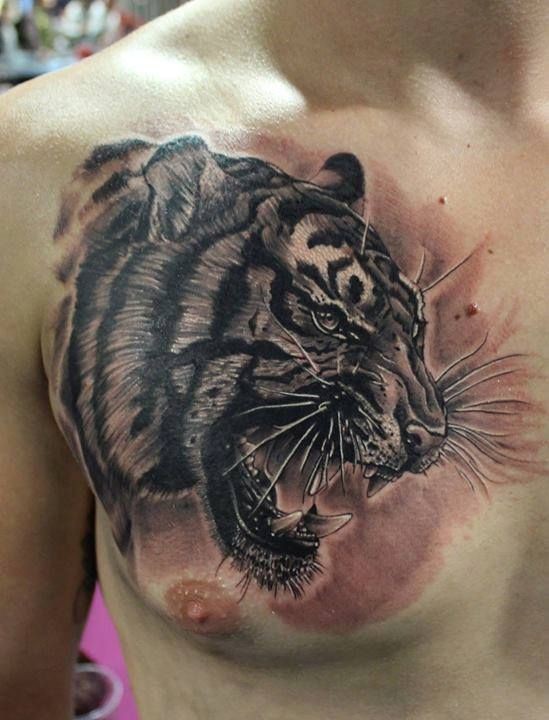 3D style black ink chest tattoo of roaring tiger