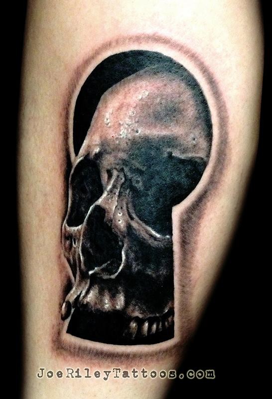 3D style black ink leg tattoo of large keyhole with human skull