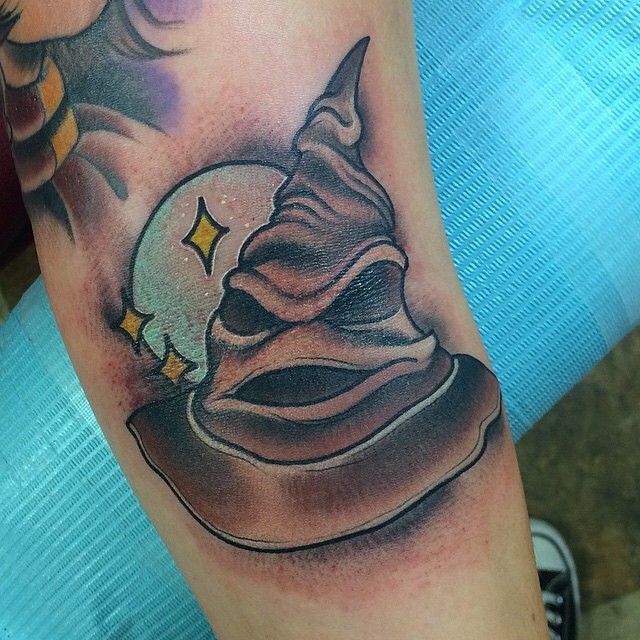3D style colored big Harry Potter magical hat tattoo on arm with moon and stars