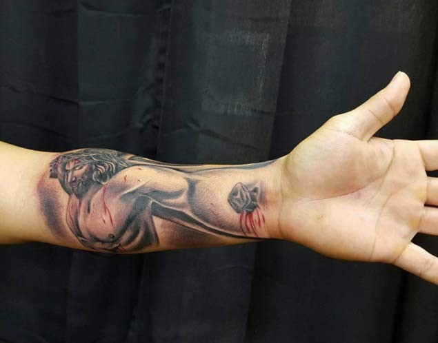 3D style colored dramatic tattoo on forearm of wounded Jesus