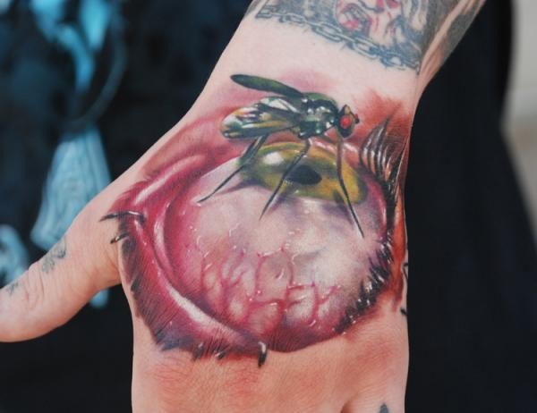 3D style colored hand tattoo of human eye and insect