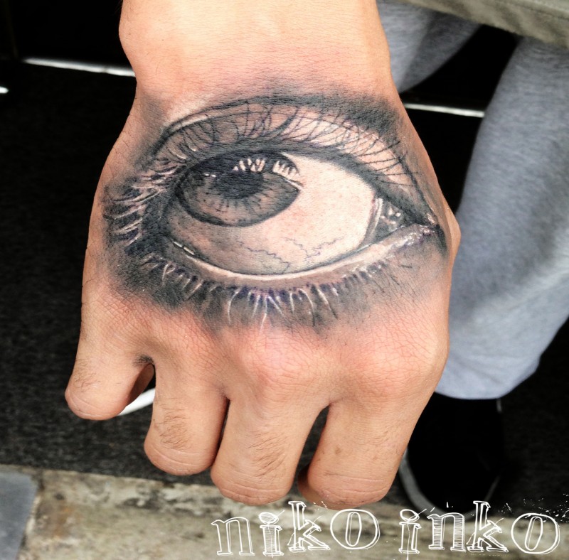 3D style colored hand tattoo of woman eye