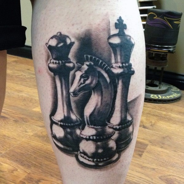 3D style colored leg tattoo of various chess statues