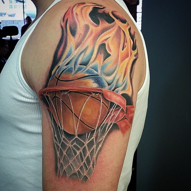 3D style colored shoulder tattoo of burning basketball with net