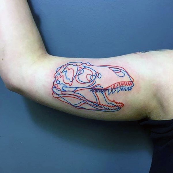 3D style colored small dinosaur skull tattoo on biceps