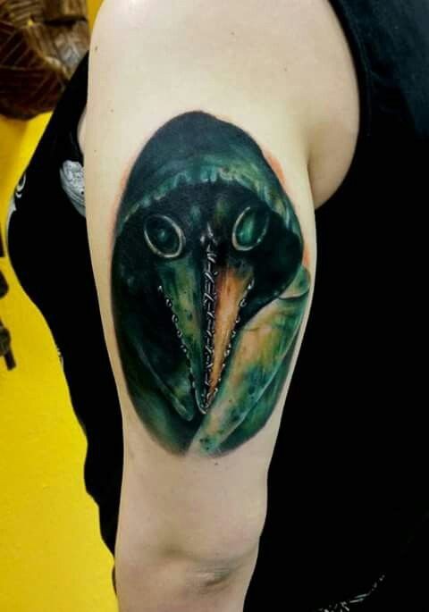 3D style colored upper arm tattoo of plague doctor