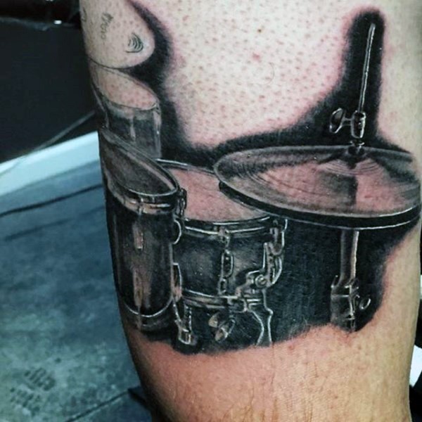 3D style designed detailed black and white drums tattoo on leg