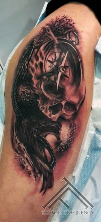 3D style detailed compass with human skull tattoo on thigh