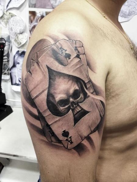 3D style detailed shoulder tattoo of playing cards stylized with skull