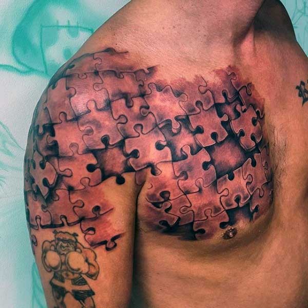 3D style incredible painted chest and shoulder tattoo of puzzle pieces