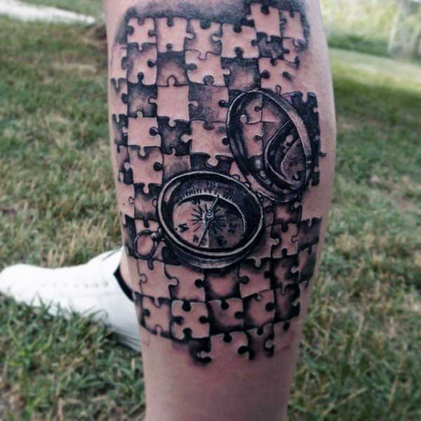3D style medium sized black ink compass tattoo with puzzle