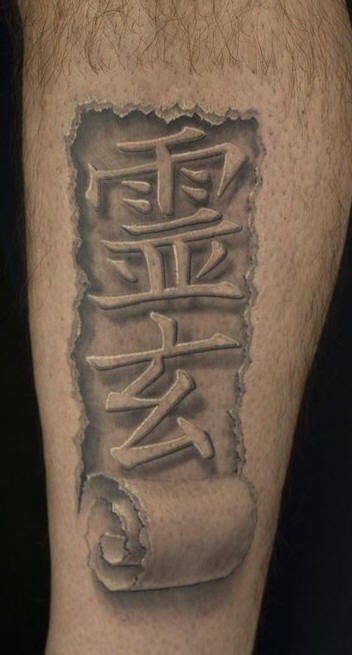 3D style painted black and white antic Asian lettering tattoo on leg
