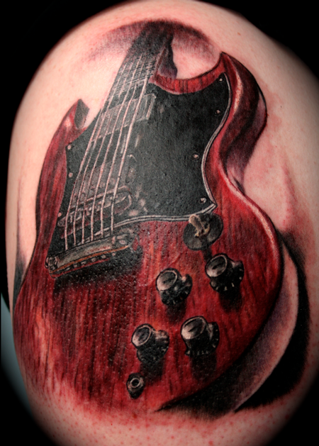 3D style realism looking shoulder tattoo of detailed guitar