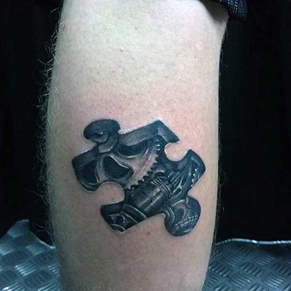 3D style typical black and white leg tattoo of puzzle piece with mechanism