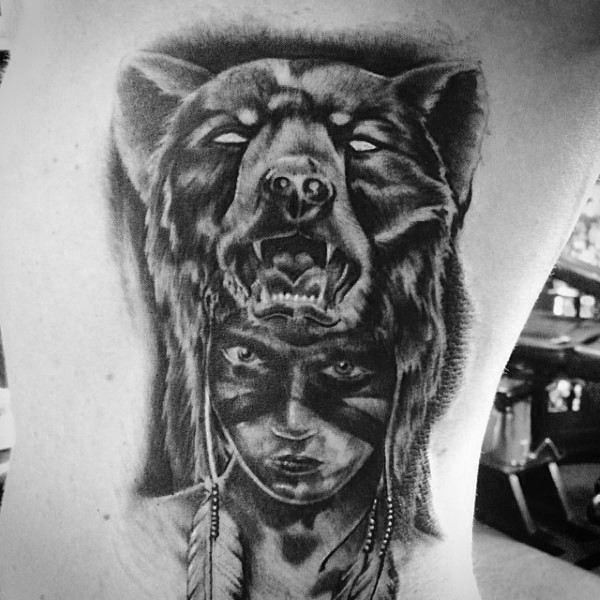 3D style very realistic looking black ink Indian portrait tattoo on side stylized with helmet from bear skin