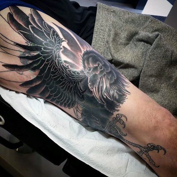 3D very realistic looking black and white mystical crow tattoo on arm