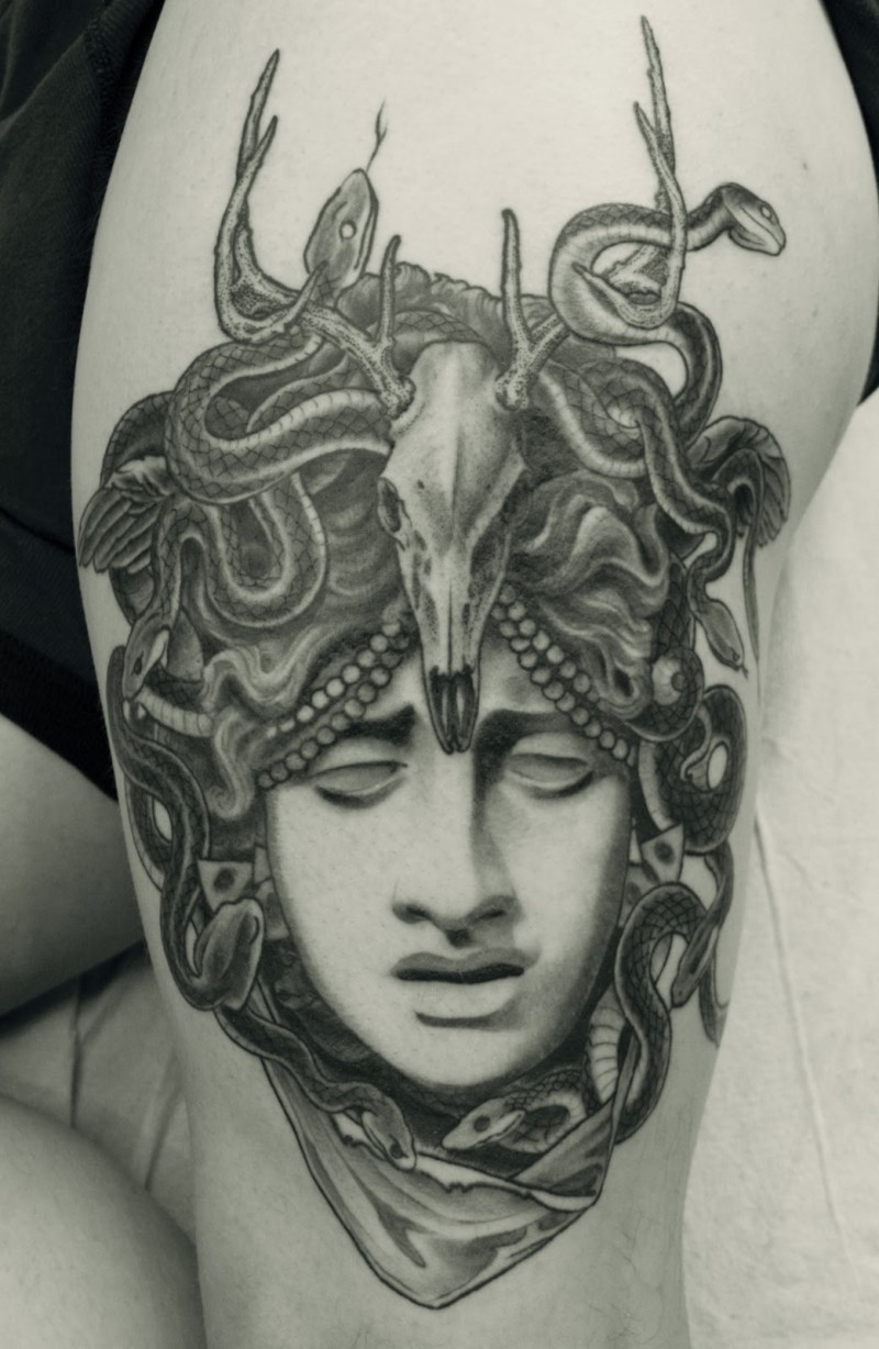 3D very realistic looking black ink sad Medusa head tattoo on thigh with snaked and animal skull