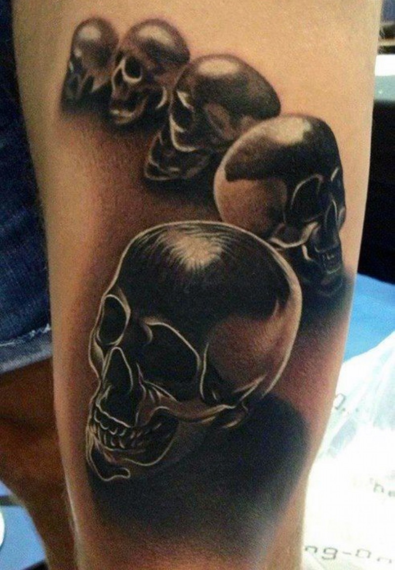 3D very realistic looking black ink skulls tattoo on thigh